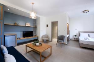 a living room with a couch and a bed and a table at ISTIO apartments in Kavála