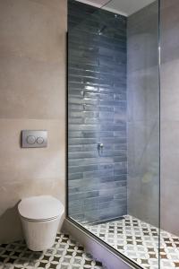 a shower stall with a toilet in a bathroom at ISTIO apartments in Kavála