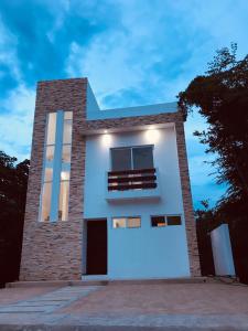 a white building with a window on top of it at 2 BR-house in Puerto Morelos with stunning view in Puerto Morelos