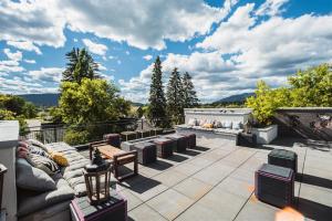 eine Terrasse mit Sofas und Tischen auf dem Dach in der Unterkunft Lupfer Unit D in Whitefish