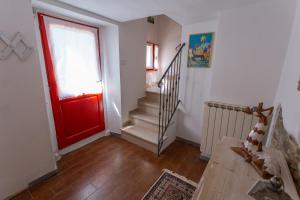 a red door in a room with a staircase at Il Gatto e la Luna in Arezzo