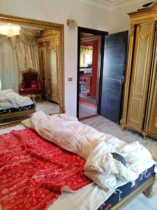 a bedroom with a large bed with a red blanket at Sunny Lakes beautiful flat for relax in Sharm El Sheikh