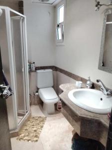 a bathroom with a toilet and a sink and a shower at Sunny Lakes beautiful flat for relax in Sharm El Sheikh