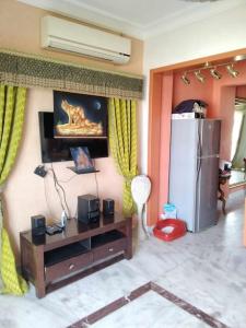 a living room with a refrigerator and a table at Sunny Lakes beautiful flat for relax in Sharm El Sheikh