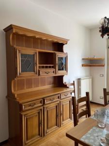 a large wooden entertainment center in a living room at Cà Maria Maurela in Ossuccio
