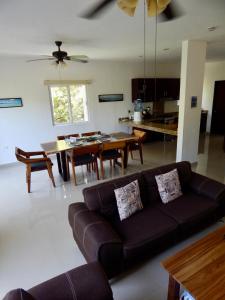 a living room with a couch and a table at 2 BR-house in Puerto Morelos with stunning view in Puerto Morelos
