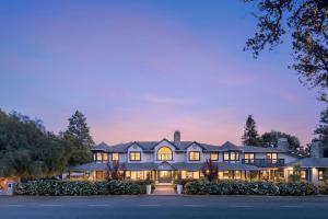 an exterior view of a large house at dusk at The Ballard Inn, A Kirkwood Collection Hotel in Ballard