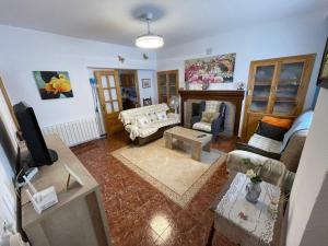 a living room with a couch and a table at Casa Amplia en el CASCO ANTIGUO de Castril in Castril