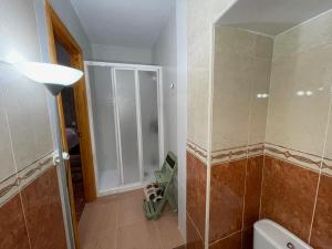a bathroom with a toilet and a glass shower door at Casa Amplia en el CASCO ANTIGUO de Castril in Castril +19 photos