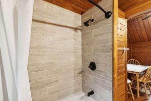a bathroom with a shower with a table at Lost Horse Lodge Double Queen Cabin 19 - PetsOK in Darby +5 photos
