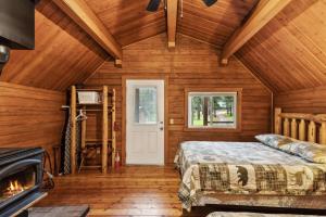 a bedroom with a bed and a fireplace at Lost Horse Lodge Double Queen Cabin 15 in Darby