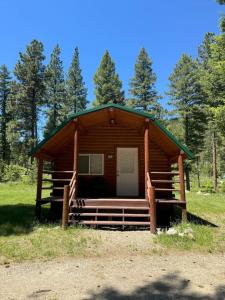 a log cabin with a porch and a door at Lost Horse Lodge Double Queen Cabin 15 in Darby