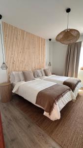 a large bedroom with a large bed with white sheets at Casa Regina Tenerife in Tamaimo