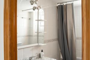 a bathroom with a sink and a mirror at Sea view apartments in Malgrat de Mar