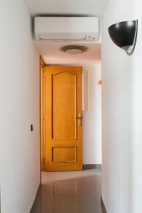 a hallway with a wooden door in a room at Sea view apartments in Malgrat de Mar +34 photos