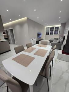 a white table and chairs in a living room at Prestige Beach Apartment in Durrës