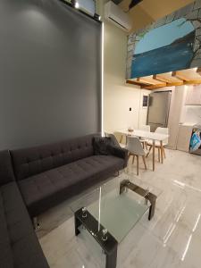 a living room with a couch and a table at The loft in Piraeus +13 photos