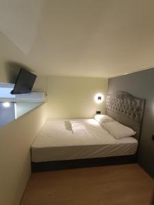 a bedroom with a bed with a laptop on it at The loft in Piraeus