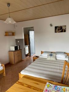 a large bedroom with two beds and a kitchen at Fala in Karwia