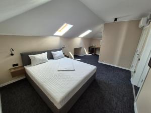 a bedroom with a large white bed in a room at SEAPOINT Boutique Hotel in Eforie Sud