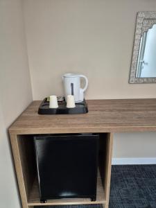 a table with a coffee cup on top of it at SEAPOINT Boutique Hotel in Eforie Sud