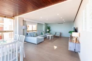 a living room with a couch and a table at Ag Bermudas Deluxe in Gandía