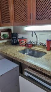 Η κουζίνα ή μικρή κουζίνα στο Loft charmoso com área de lazer