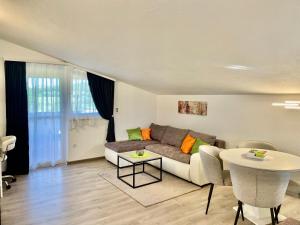 a living room with a couch and a table at Apartments Dora in Poreč