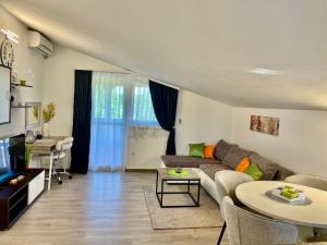 a living room with a couch and a table at Apartments Dora in Poreč