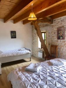 a bedroom with two beds and a ceiling at La Riviere Esperance in Veyrignac