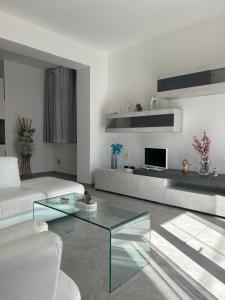a living room with a couch and a glass coffee table at Il Boschetto in Torgiano