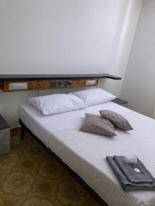 a bed with two pillows on it in a room at La stalla in Magione