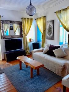 a living room with a couch and a coffee table at The Corner House - Charming Rustic Home in the Heart of Monchique in Monchique