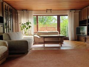 a living room with a couch and a table at Haus Thea bei Stuttgart in Leonberg