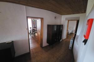 a living room with a television and a dining room at Casa da Avó Clotilde in São Roque do Pico