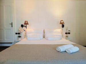 a bed with two pillows and two towels on it at B&B Casa del Bosco in San Michele al Tagliamento +31 photos