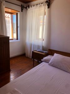 a bedroom with two beds and a window at Apartment in Marathokampos Samos in Samos