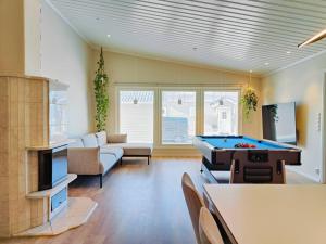 a living room with a pool table in it at The Sunny Villa in Kokkola