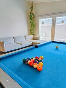 a living room with a pool table with balls on it at The Sunny Villa in Kokkola