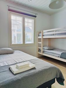 a bedroom with two bunk beds and a window at The Sunny Villa in Kokkola