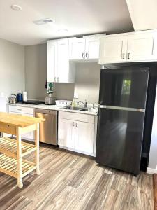 a kitchen with a black refrigerator and a table at Panoramic Views in Ashland
