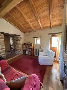 a living room with a couch and a chair at Le Mas du Savel in Gagnières