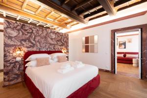 a bedroom with a large white bed in a room at My Trevi Suite & Apartment in Rome