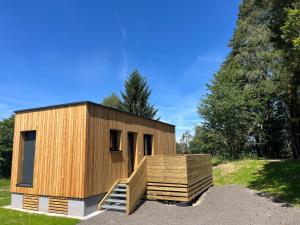 a small wooden building with a staircase in a yard at Tiny House Waldviertel in Waidhofen an der Thaya