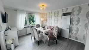 a kitchen and dining room with a table and chairs at Maison Lily Apartment 1 in Bad Lauterberg