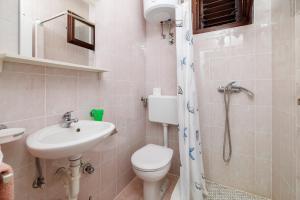 a bathroom with a toilet and a sink and a shower at Apartman Antonia in Crikvenica +18 photos