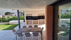 a patio with a table and chairs in a house at Exclusiva Villa, Lujo y Descanso in Benicàssim +65 photos