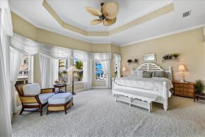 a bedroom with a white bed and a butterfly on the ceiling at Ocean Vue By Beachside Management in Siesta Key