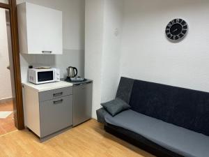 a living room with a couch and a microwave at Apartman DIVA in Jajce