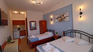 a small room with two beds and a kitchen at Amalia in Stavros